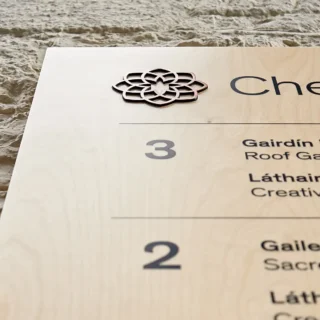 Closeup an orientation board in the Chester Beatty Lobby. The sign is made out of high quality ply wood with black screen printed letters and Copper insets for the logo and to mark what floor you are on.