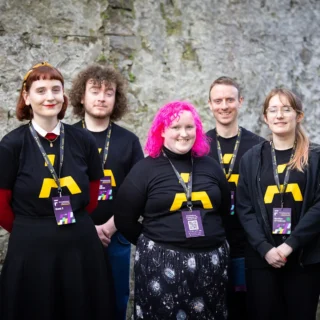 A group of people wearing black tshirts with the Ardán logo.