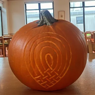 Large pumpkin with the Údarás na Gaeltachta logo carved into it.