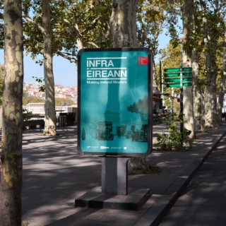 Infra Éireann poster featuring an old photo of Busárás Dublin with a duotone treatment. The poster is set on a monolith in a European street scape.
