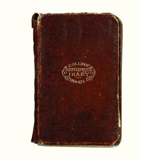 Cover of Michael Collins’ 1919 diary. It is a burgundy colour and features a small gold embossed stamp with serif type 