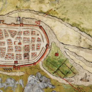 A historical map of Galway, enclosed by fortified walls. The map shows a grid layout of streets with small buildings, towers, and gates, surrounded by bodies of water on. Several ships are depicted in the water, and nearby land areas are illustrated with hills, greenery, and additional structures. The map is hand-drawn with topography and a medieval style.