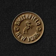 Smithfield New York brass coin badge featuring a rearing horse and football motifs
