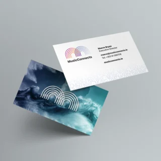 Music Connects business cards with logo on ons side and crashing waves with an overlaid white logo on the other side
