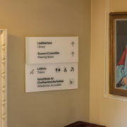 Directional signage pointing to the Library entrance with bilingual Irish and English text