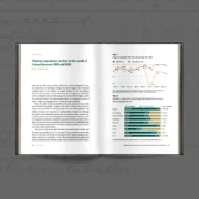 Open hardback book showing Chapter 21 of The Story of Us: 'Minority population decline in the south of Ireland between 1911 and 1926', with charts comparing Catholic and non-Catholic population decline across the 26 counties.