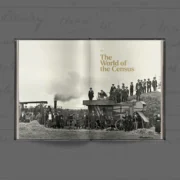Open hardback book showing the Part 1 section opener 'The World of the Census', with a full-bleed black and white photograph of a large group of farm workers gathered around a threshing machine.